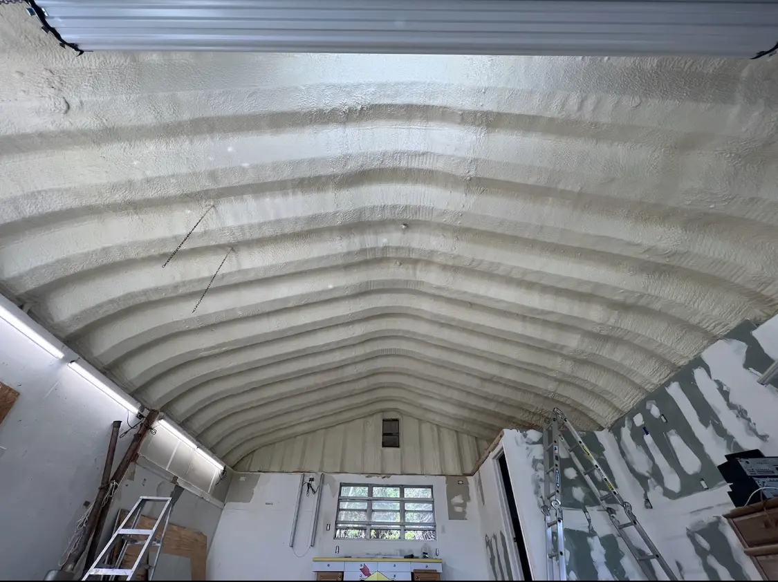 Spray polyurethane foam applied to the underside of a metal roof deck in Robinson
